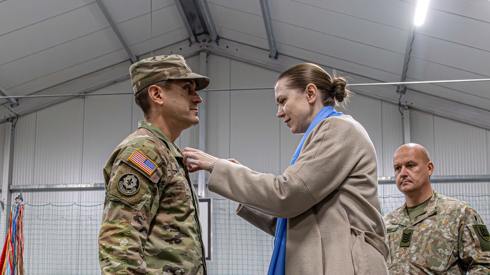 U.S. Army Soldier receives the Medal of the National Defense System of the Republic of Lithuania during a transfer of authority ceremony