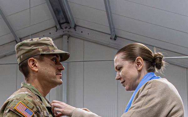 U.S. Army Soldier receives the Medal of the National Defense System of the Republic of Lithuania during a transfer of authority ceremony