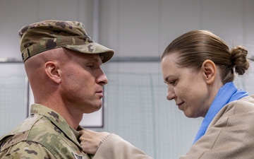 U.S. Army Soldier receives the Medal of the National Defense System of the Republic of Lithuania during a transfer of authority ceremony