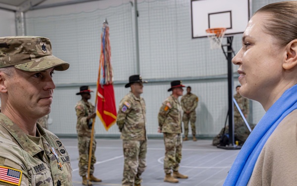 U.S. Army Soldier receives the Medal of the National Defense System of the Republic of Lithuania during a transfer of authority ceremony