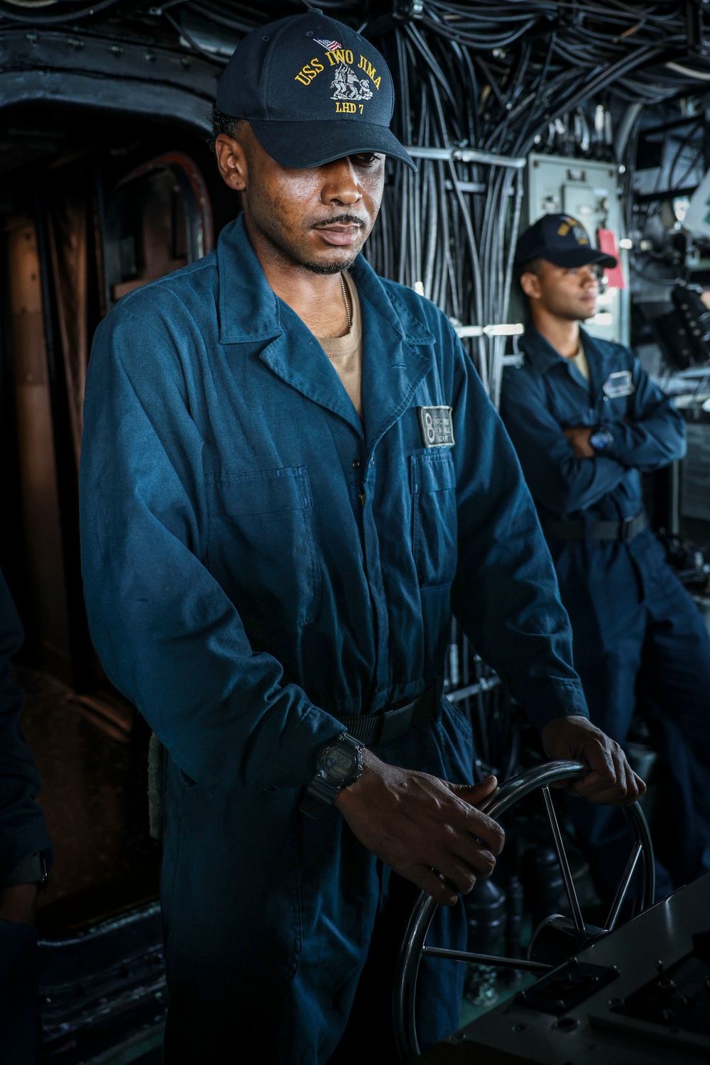 USS Iwo Jima Sailor Stands Watch as the Helmsman