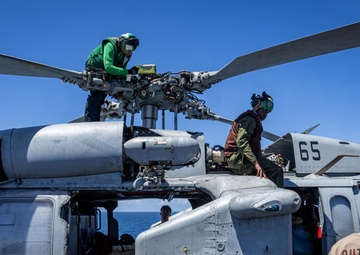 USS Iwo Jima Sailors Conduct Maintenance on a MH-60S
