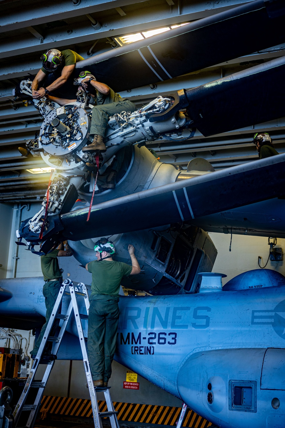 U.S. Marines Work in the Hangar Bay of USS Iwo Jima (LHD 7)