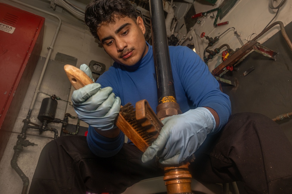 USS Iwo Jima (LHD 7) Sailor Maintains Ship Equipment
