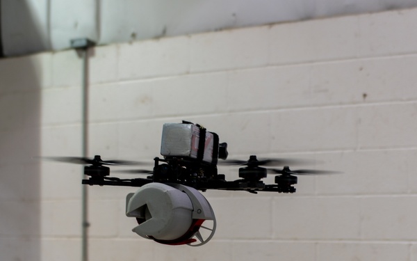 ABE 101 holding a mockup for a droppable grenade