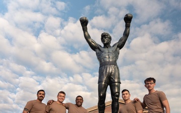 Sailors and Marines run the Rocky Steps during Navy and Marine Corps 250
