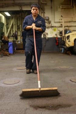 Iwo Jima Sailors Clean-up the Upper Veihcle Stowage Area [Image 3 of 12]