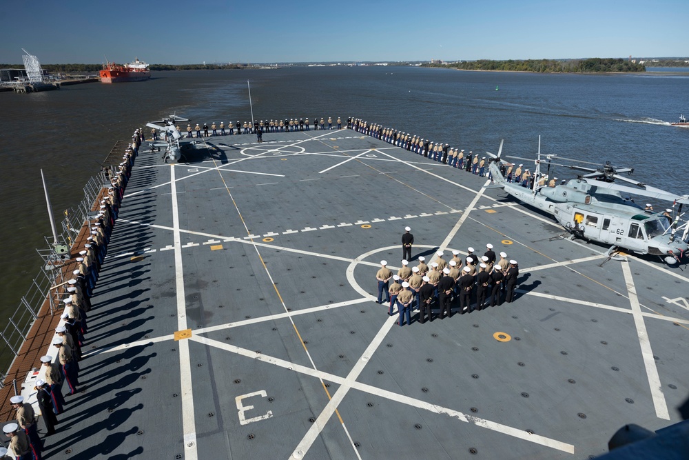 U.S. Marines and Sailors man the rails aboard the USS Arlington
