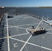 U.S. Marines and Sailors man the rails aboard the USS Arlington