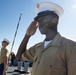 U.S. Marines and Sailors man the rails aboard the USS Arlington
