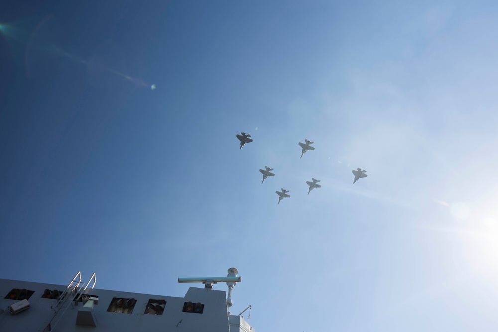 U.S. Marines and Sailors man the rails aboard the USS Arlington
