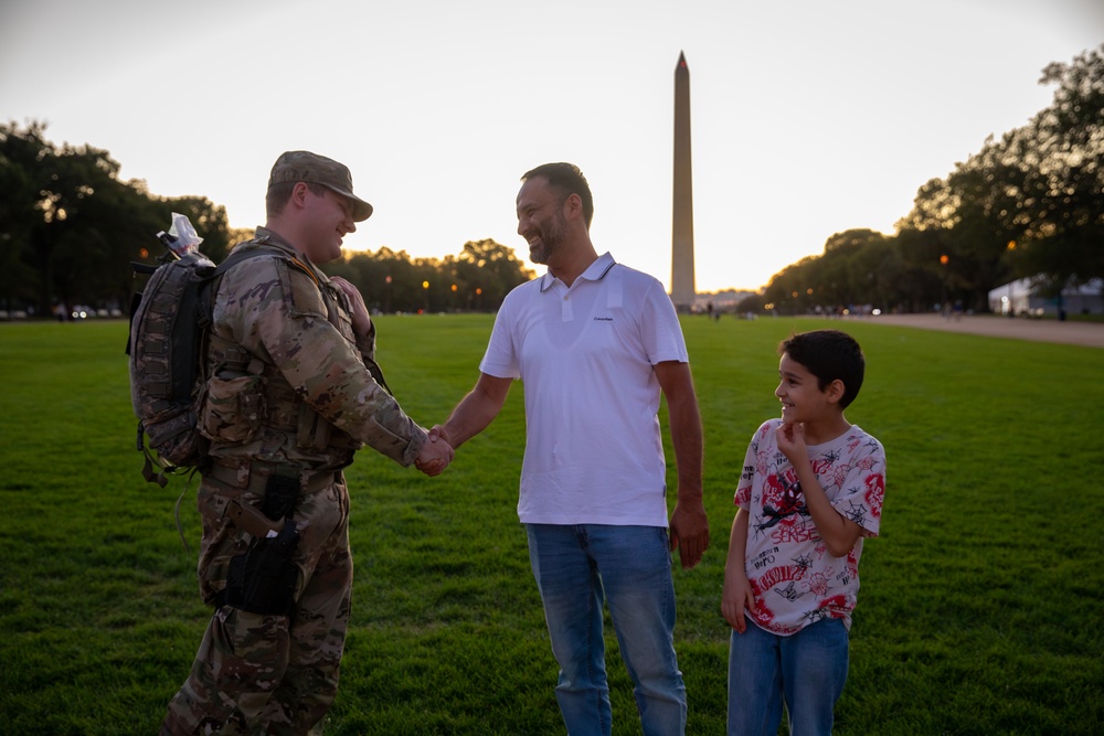 A Mississippi Army National Guard Soldier shakes hands with a civilian on the National Mall
