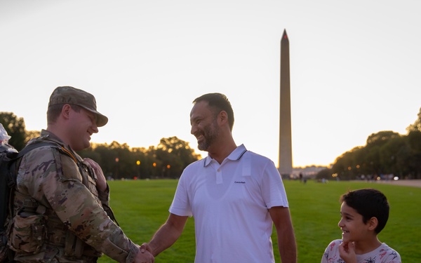 A Mississippi Army National Guard Soldier shakes hands with a civilian on the National Mall