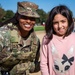 A Mississippi Army National Guard Soldier takes a photo with a civilian