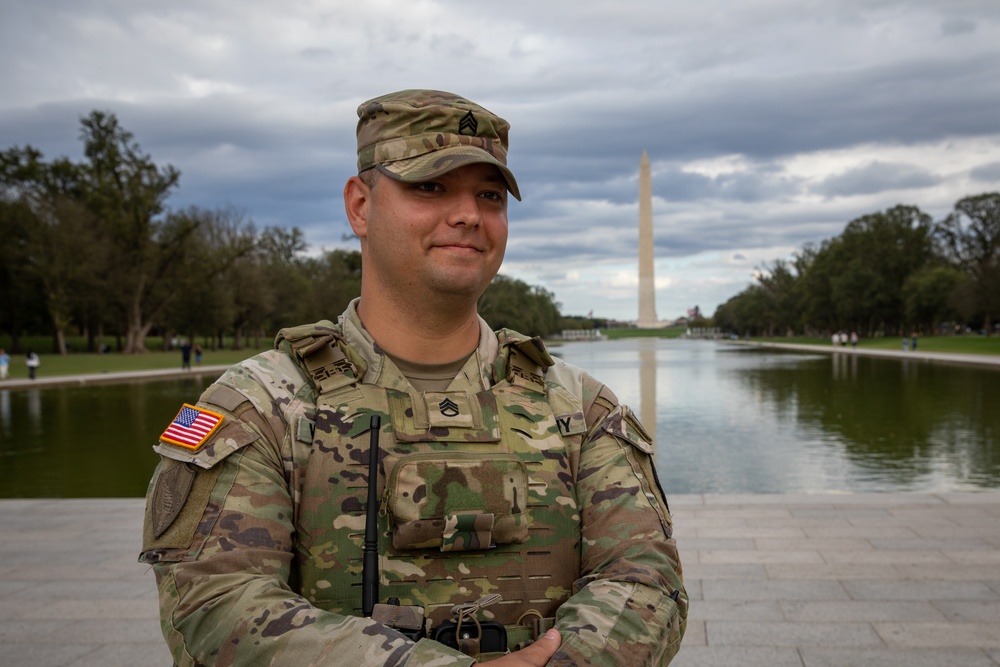 A Mississippi Army National Guard Soldier on patrol in front of the Lincoln Memorial Reflecting Pool