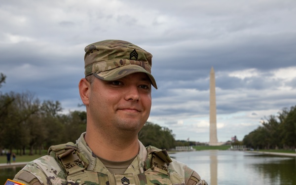 A Mississippi Army National Guard Soldier on patrol in front of the Lincoln Memorial Reflecting Pool
