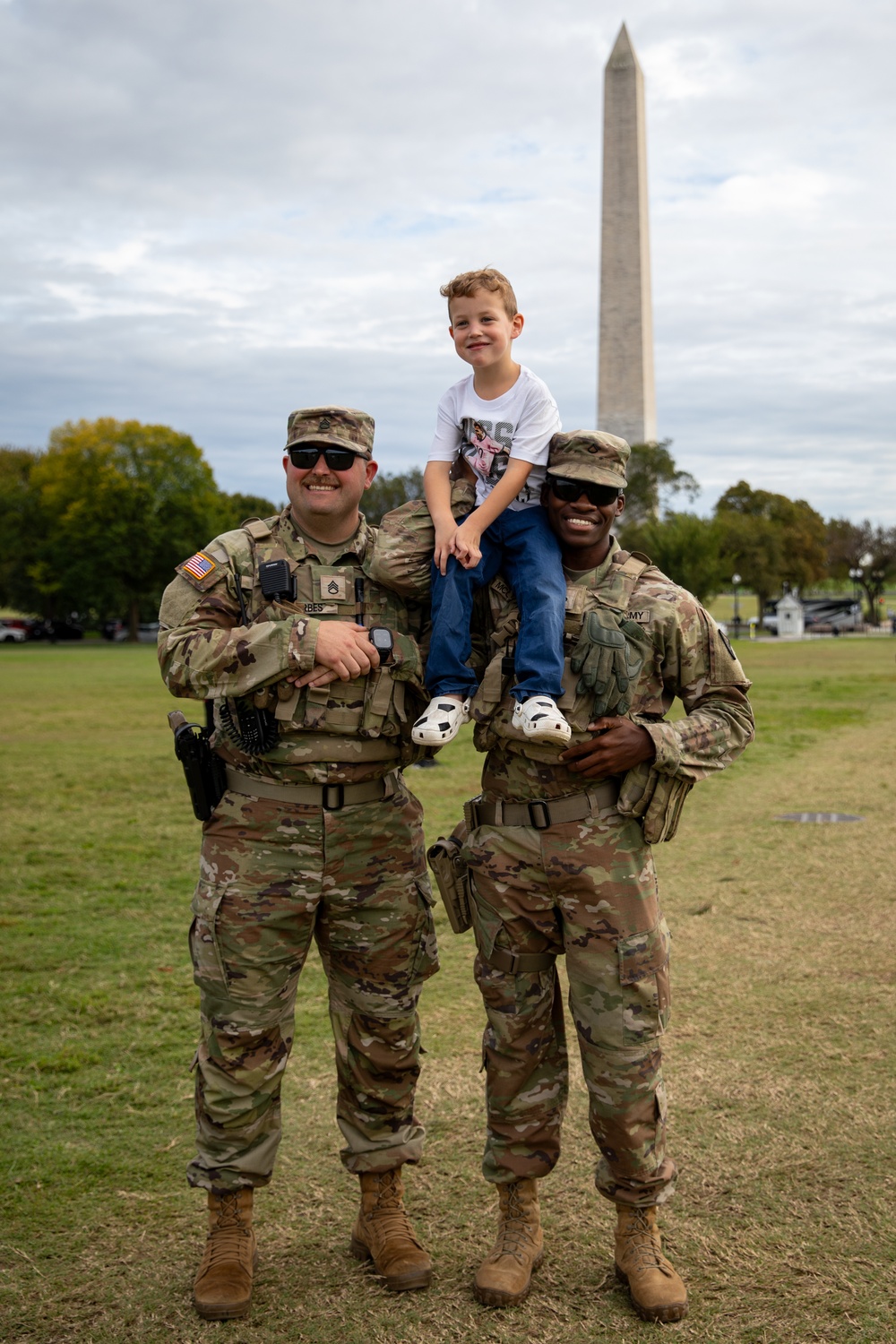 Mississippi Army National Guard Soldiers take a photo with a member of the public