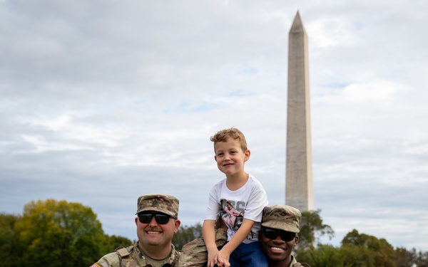 Mississippi Army National Guard Soldiers take a photo with a member of the public