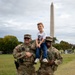 Mississippi Army National Guard Soldiers take a photo with a member of the public