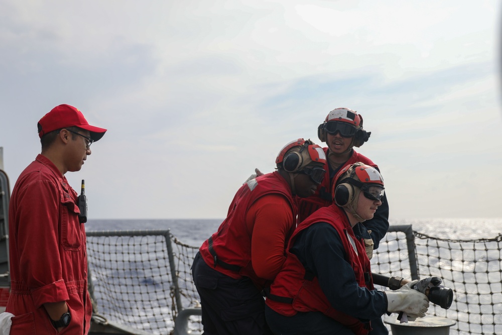 Sailors aboard the USS John Finn conduct a crash and salvage drill in the Philippine Sea