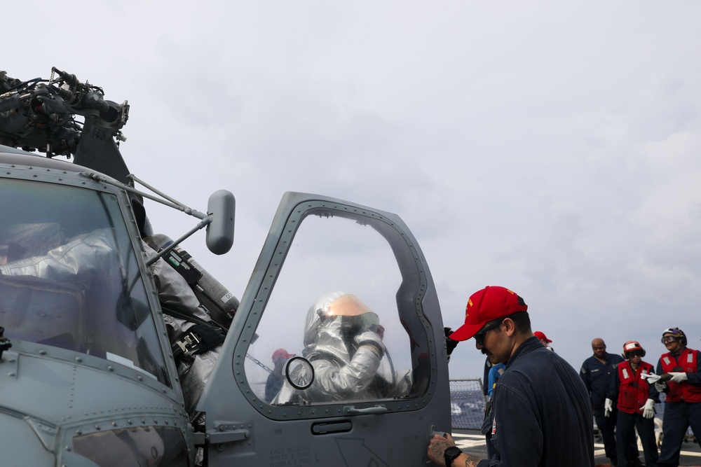 Sailors aboard the USS John Finn conduct a crash and salvage drill in the Philippine Sea