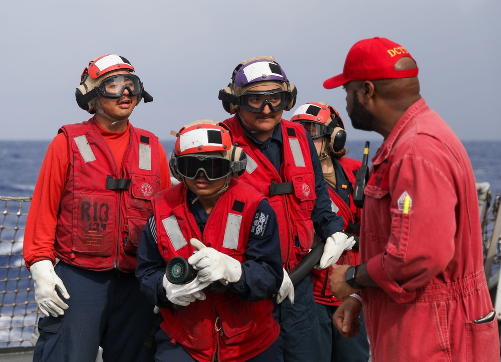Sailors aboard the USS John Finn conduct a crash and salvage drill in the Philippine Sea