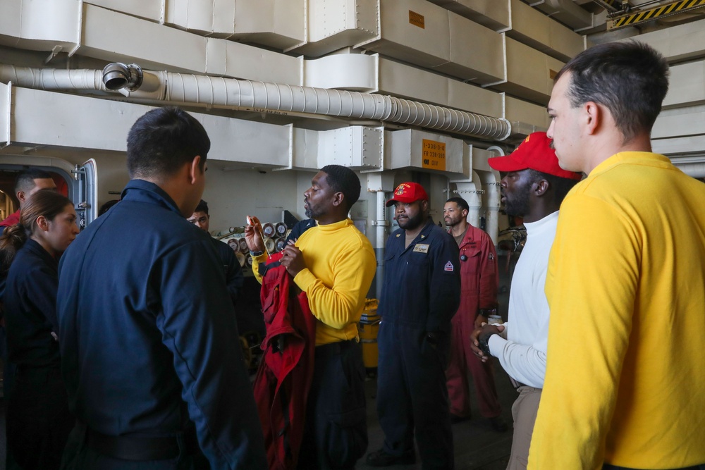 Sailors aboard the USS John Finn conduct a crash and salvage walkthrough in the Philippine Sea