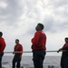 Sailors aboard the USS John Finn conduct flight quarters in the Philippine Sea