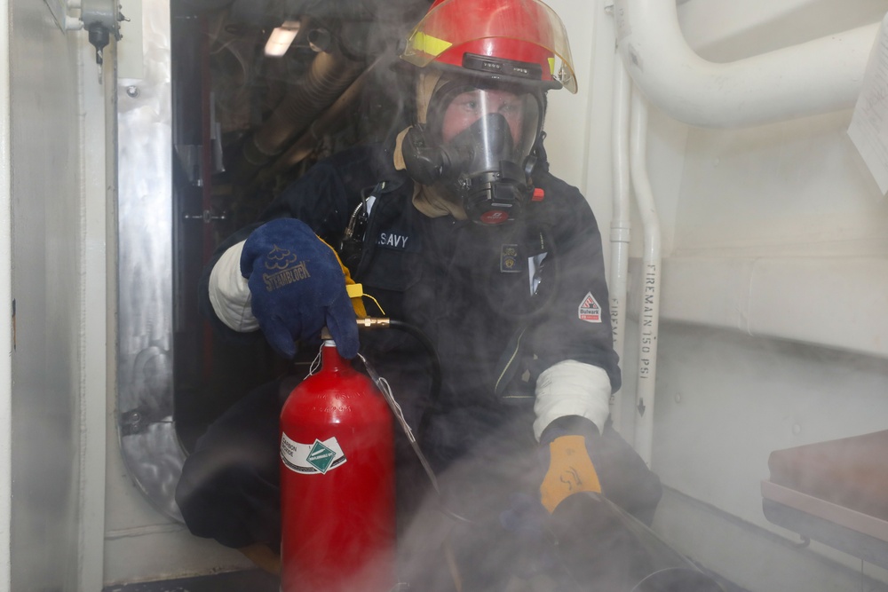 Sailors aboard the USS John Finn conduct a damage control drill in the Java Sea
