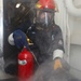 Sailors aboard the USS John Finn conduct a damage control drill in the Java Sea