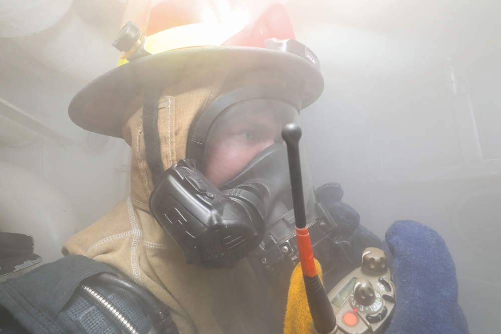 Sailors aboard the USS John Finn conduct a damage control drill in the Java Sea