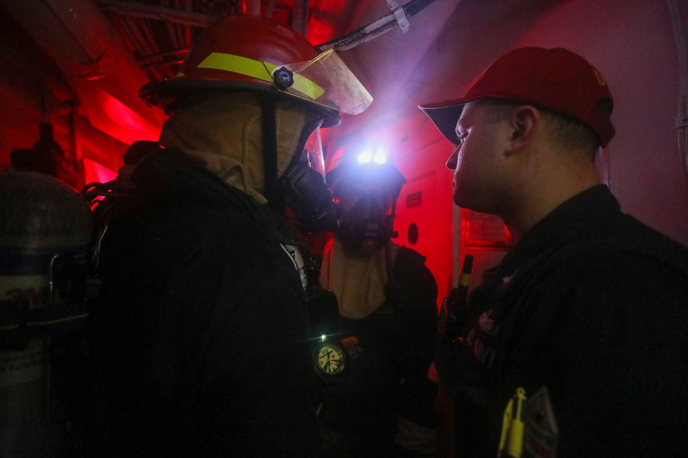 Sailors aboard the USS John Finn conduct a damage control drill in the Java Sea