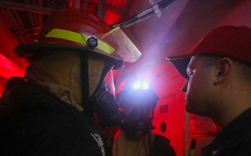 Sailors aboard the USS John Finn conduct a damage control drill in the Java Sea