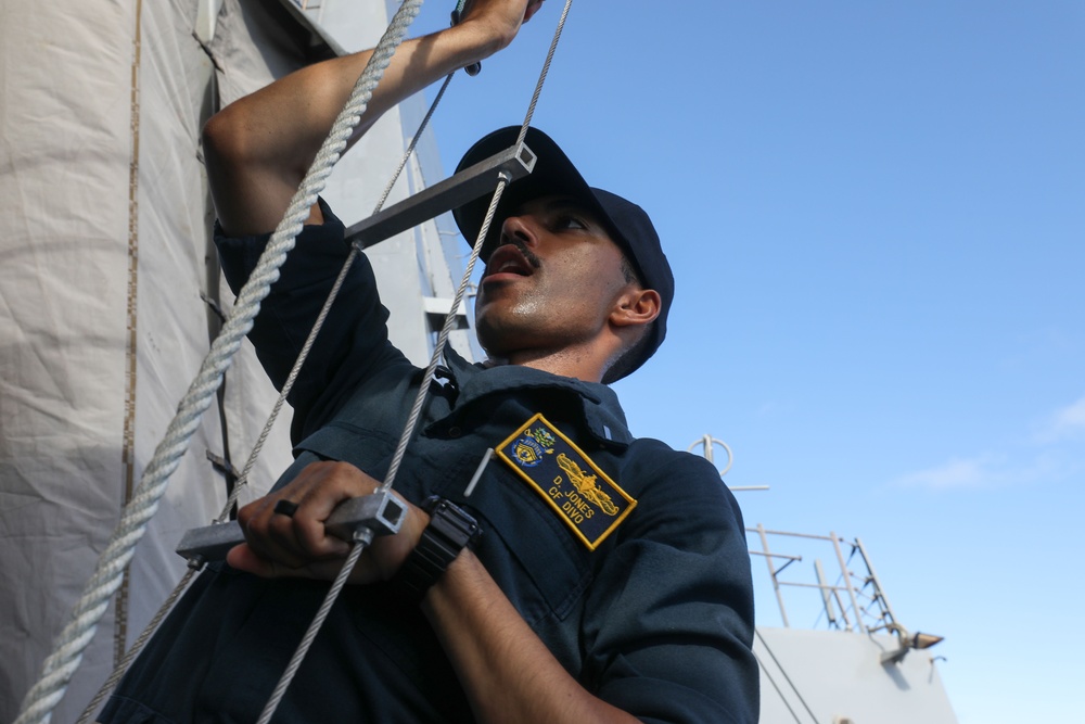 Sailors aboard the USS John Finn conduct a visit, board, search, and seizure drill in the Philippine Sea