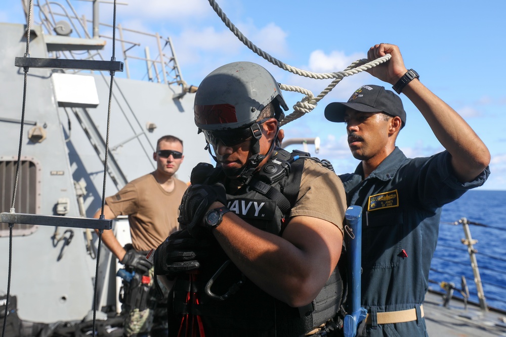 Sailors aboard the USS John Finn conduct a visit, board, search, and seizure drill in the Philippine Sea