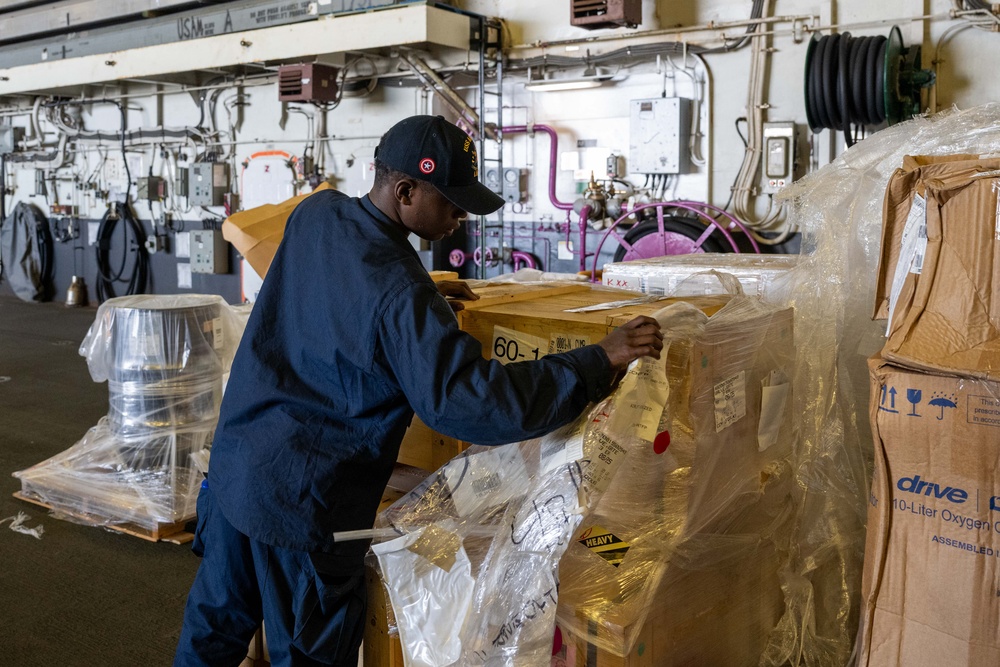 USS America (LHA 6) Conducts Stores Onload in the Hangar Bay