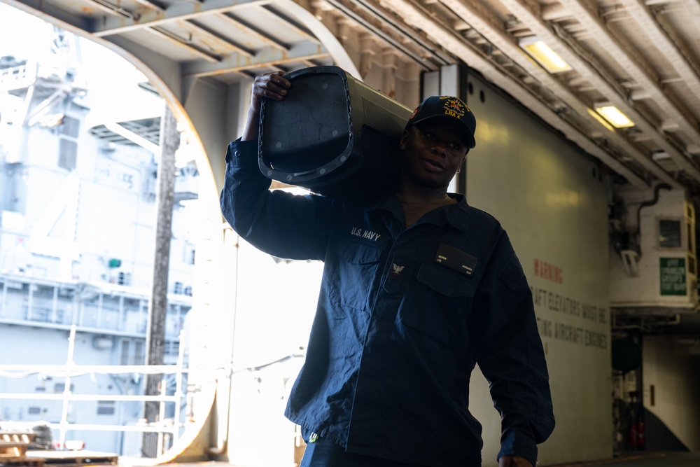 USS America (LHA 6) Conducts Stores Onload in the Hangar Bay
