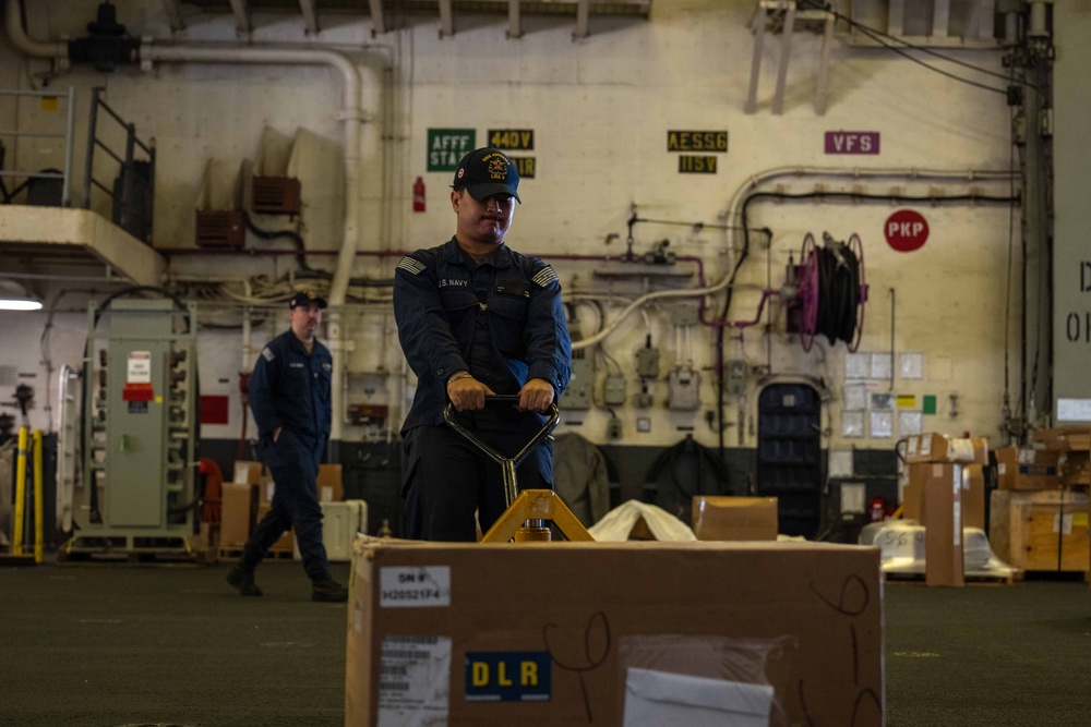 USS America (LHA 6) Conducts Stores Onload in the Hangar Bay