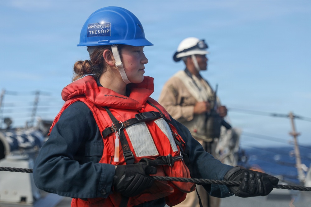 Sailors aboard the USS John Finn conduct a replenishment at sea with the USNS Rappahannock in the South China Sea
