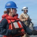 Sailors aboard the USS John Finn conduct a replenishment at sea with the USNS Rappahannock in the South China Sea
