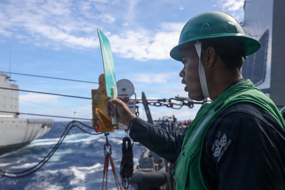 Sailors aboard the USS John Finn conduct a replenishment at sea with the USNS Rappahannock in the South China Sea