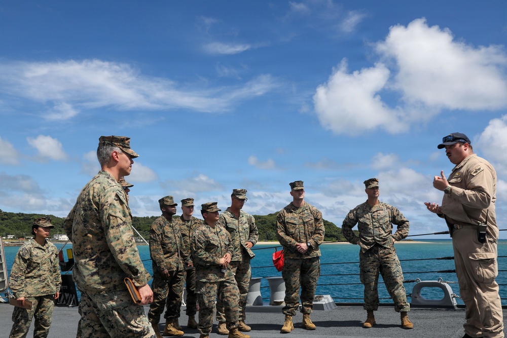 Sailors aboard the USS John Finn give a ship tour to Marines assigned to the 12th Littoral Combat Team and 3rd Marine Division in Okinawa, Japan