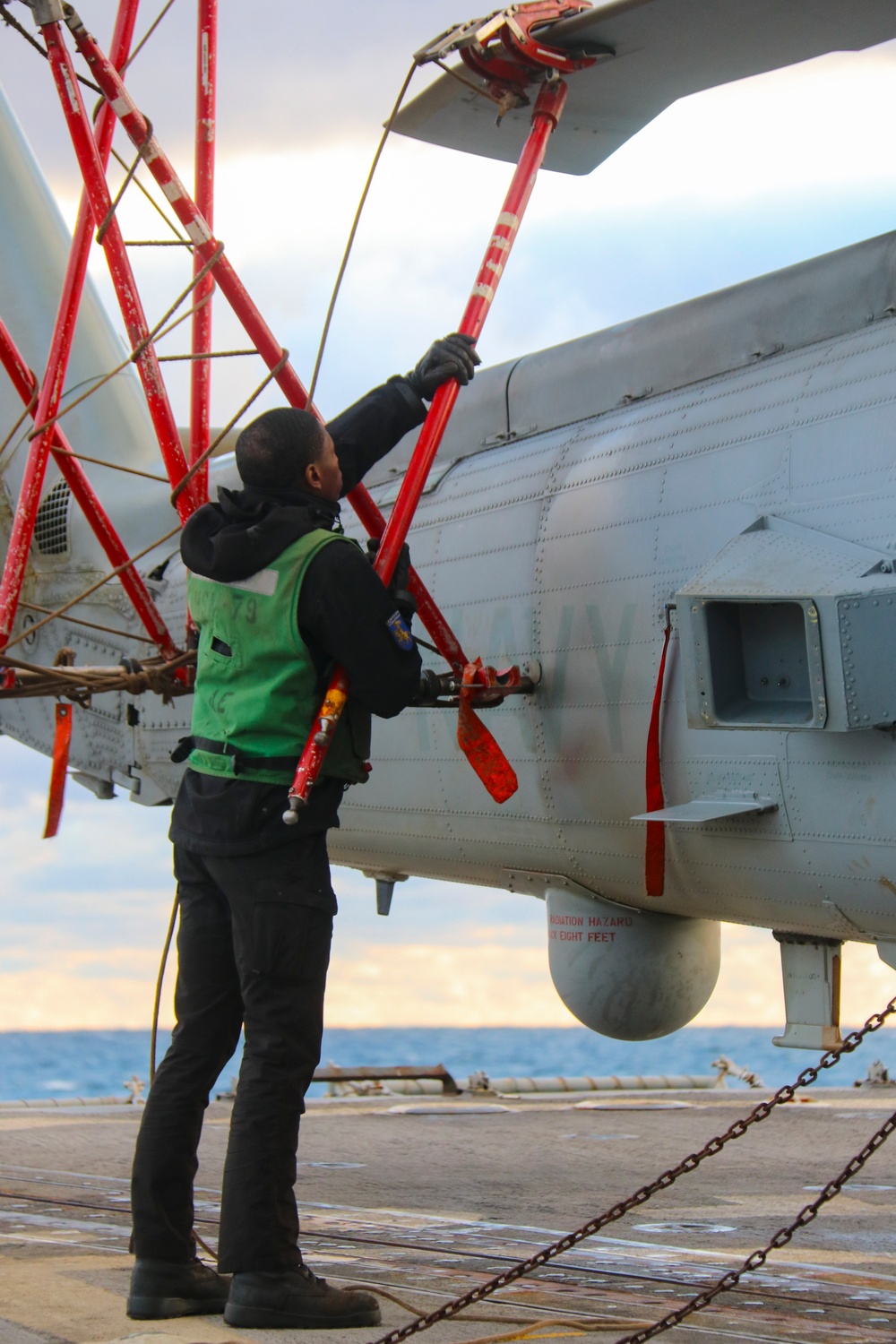AMSA Jeremiah Cobb secures the final blade on an MH-60R Sea Hawk