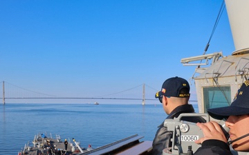 Cmdr. Anthony LaVopa and QMSA Nicole Guijosa take navigational bearing from thebridge wing