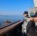 Cmdr. Anthony LaVopa and QMSA Nicole Guijosa take navigational bearing from thebridge wing