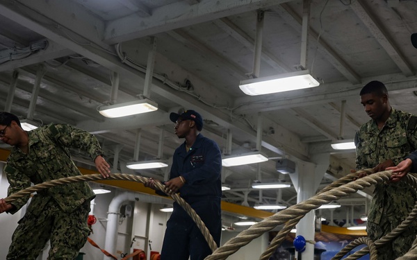 USS Iwo Jima Sailors Heave In Lines During Sea and Anchor Evolution