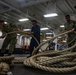 USS Iwo Jima Sailors Heave In Lines During Sea and Anchor Evolution