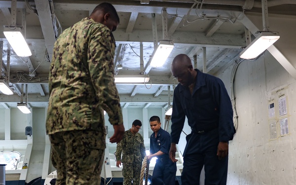USS Iwo Jima Sailors Heave In Lines During Sea and Anchor Evolution