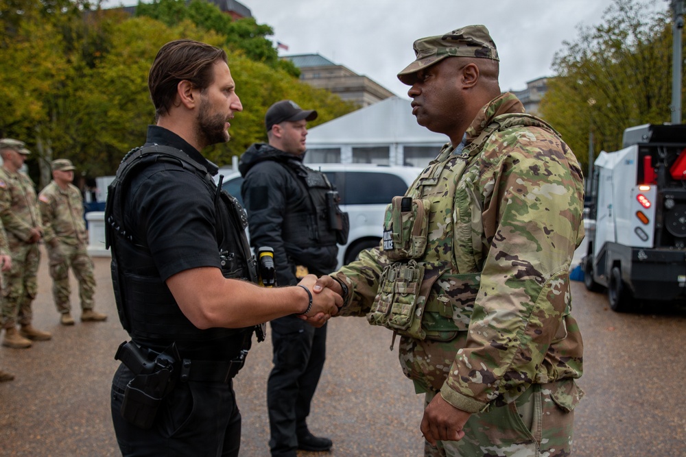 Joint Task Force Magnolia Commander, Lt. Col. Steven Jackson, shakes hands with a Secret Service Officer