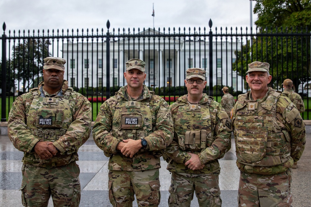 Leadership from Task Force Magnolia take a photo in front of the White House